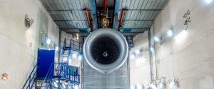 Close up of a large aircraft engine mounted for testing in an enclosed test at GA Telesis Engine Services