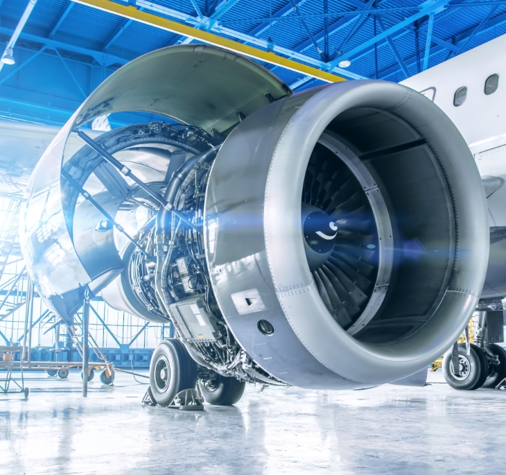 Jet engine with detailed components in an aircraft hangar.